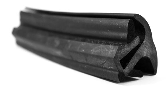 Complex coextruded foam and rubber door seal with rubber bloom 
